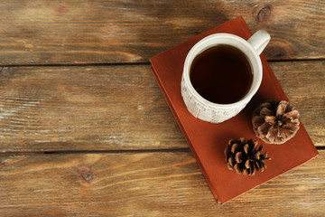 Cup of tea with book on table close-up