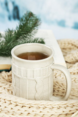 Cup of tea with book on table close-up