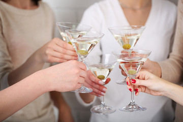 Woman hands with glasses of martini close-up