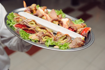 Waiter Holding Tray with Meat
