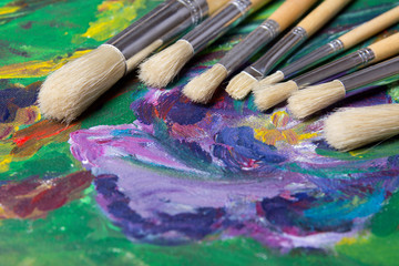 close up of paint brushes on canvas background