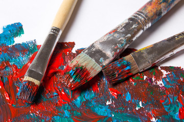 used brushes and paint background with blue and red strokes