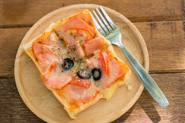 Pizza, snacks, extra plate on wood