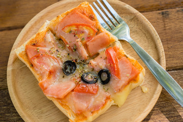 Pizza, snacks, extra plate on wood