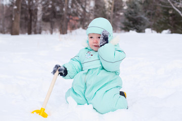 Fototapeta na wymiar Cute baby boy playing in park in winter