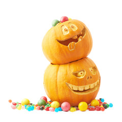 Two Halloween pumpkins filled with candies