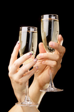 Two clink glasses over black background. Romantic background