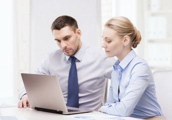 business team working with laptop in office