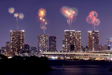 Fireworks celebrating over Odaiba, Tokyo cityscape at night