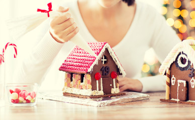 close up of woman making gingerbread houses