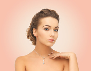 beautiful woman wearing shiny diamond pendant
