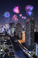 Fireworks celebrating over Tokyo cityscape at night