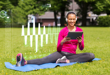 smiling woman with tablet pc outdoors