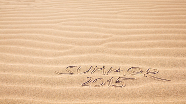 Summer 2015 handwriting on the sea-sand with a wavy pattern