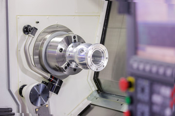 operator turning aluminium autopart by cnc lathe