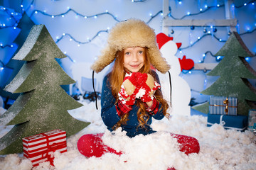 beautiful girl in a hat in the snow