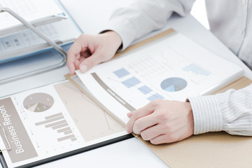 Businessman analyzing investment charts. Accounting