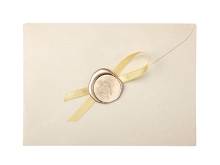 old mail envelope with gold wax seal stamps isolated on white