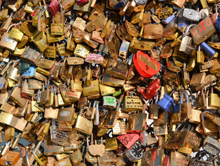 Lots of colorful locks on a bridge in Paris, France.