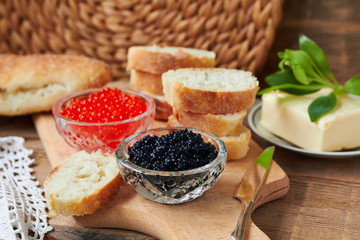 Red and black caviar in glass jars,bread and butter