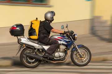 Busy messenger on motorcycle