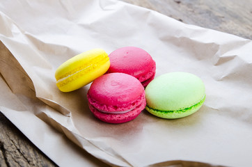 Colorful macaroons on a dark wooden background