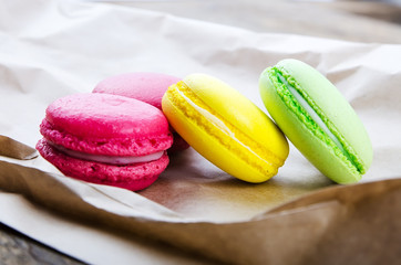 Colorful macaroons on a dark wooden background