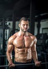 Fototapeta na wymiar Man doing weight lifting in gym