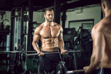 Fototapeta na wymiar Man doing weight lifting in gym