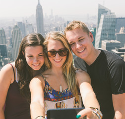 Friends Taking Selfie with New York on Background