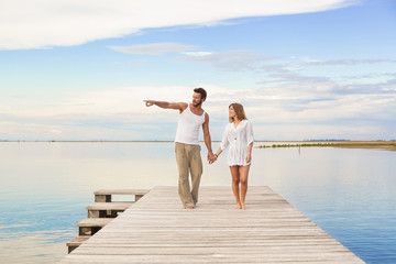Couple walking and pointing to the horizon
