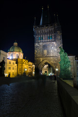 Obraz premium Prague. Tower on the Charles Bridge in the night illumination.