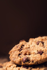 Chocolate chip cookies on wooden background. Stacked chocolate c