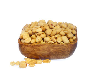 Salted, roasted, peanuts in a wooden bow, on white background
