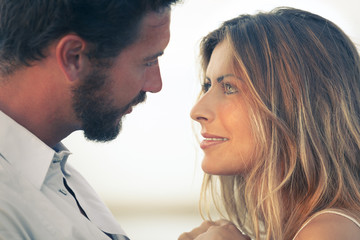 woman and her man face to face at a sunset