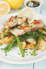 Cod fish steak with fried potato and green bean