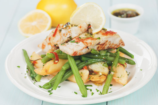 Cod fish steak with fried potato and green bean