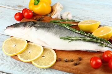 Fresh raw fish and food ingredients on table
