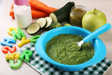 Fresh baby food in bowl with spoon