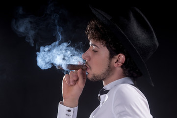 Young man close up portrait with cigar