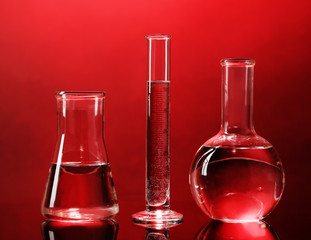 Test tubes with liquid on dark colorful background