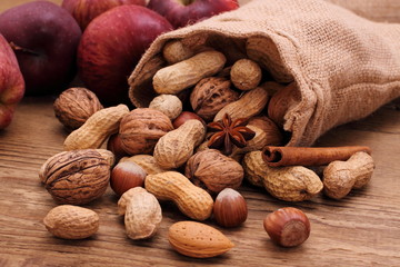 Various nuts in jute sack cinnamon sticks, star anise