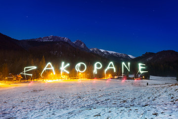 Zakopane sign under Tatra mountains at night, Poland - obrazy, fototapety, plakaty