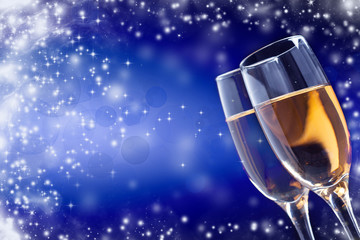 Champagne glasses against holiday lights