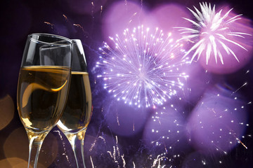 Glasses with champagne against fireworks