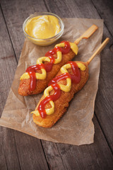 Corn dog with mustard and ketchup