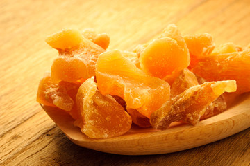 Closeup candied ginger on wooden spoon