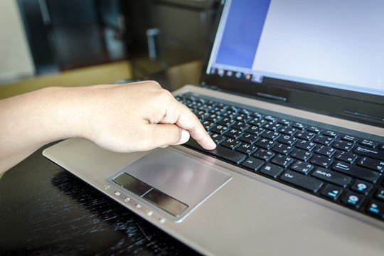 Hand using laptop