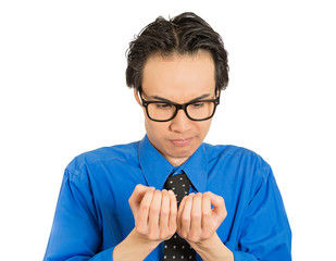 perfectionist man with glasses anxiously looking at fingernails