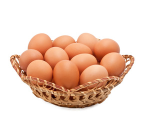 Eggs in a small basket on white background